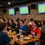 Xoilac fans enjoying live sports betting experience in a vibrant sports bar atmosphere.