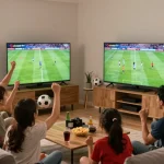 Fans enjoying a live football match on lương sơn tv in a cozy living room with snacks and memorabilia.